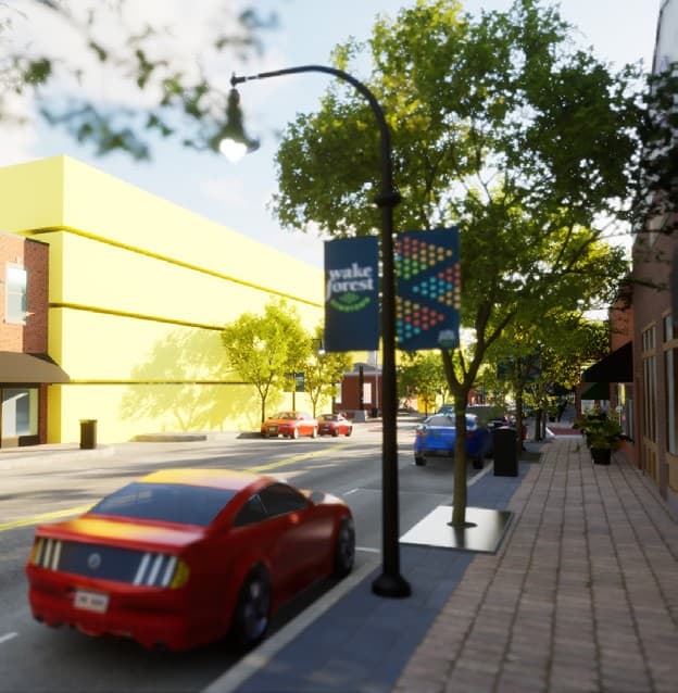 Street view in the digital twin with a proposed multi-storey building in yellow massing behind the existing streetscape